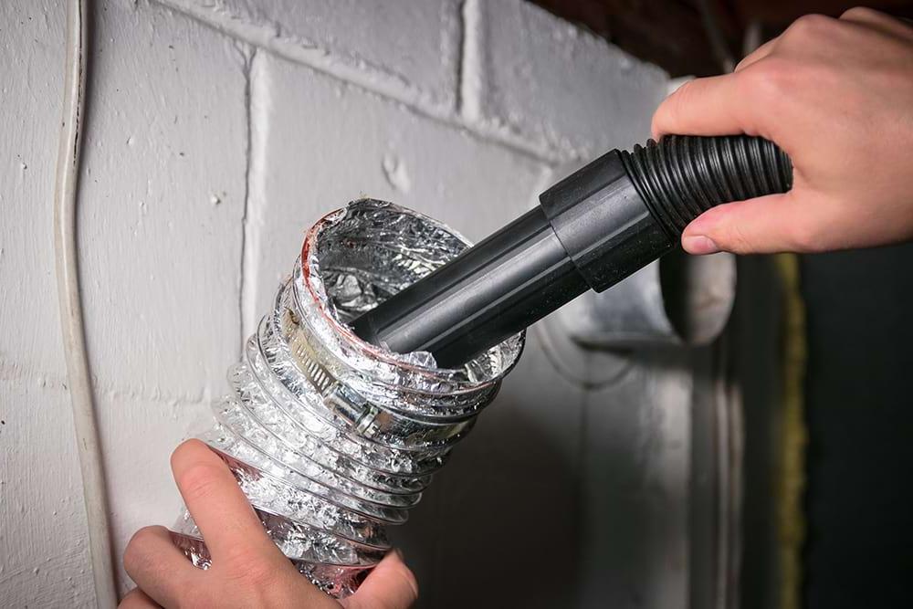 Person using vacuum to clean dryer vent